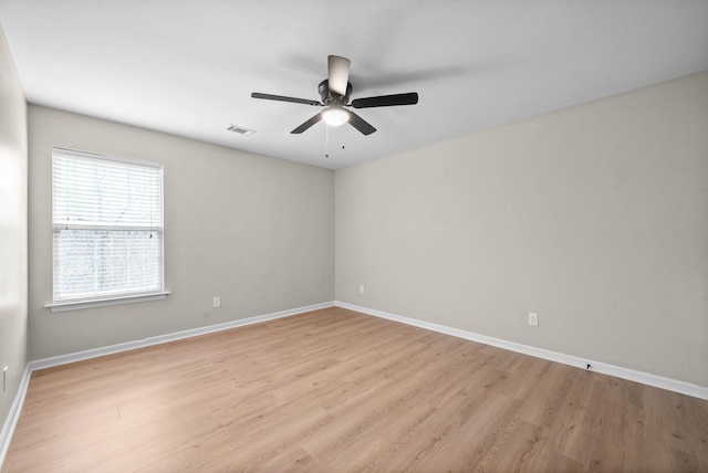 unfurnished room with visible vents, a ceiling fan, baseboards, and light wood-type flooring