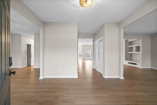 foyer entrance featuring baseboards and wood finished floors