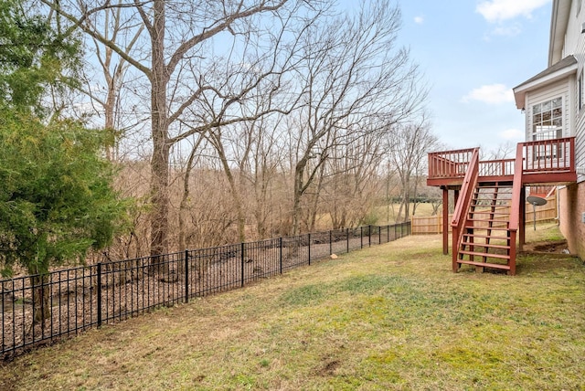 view of yard with stairs, a fenced backyard, and a wooden deck