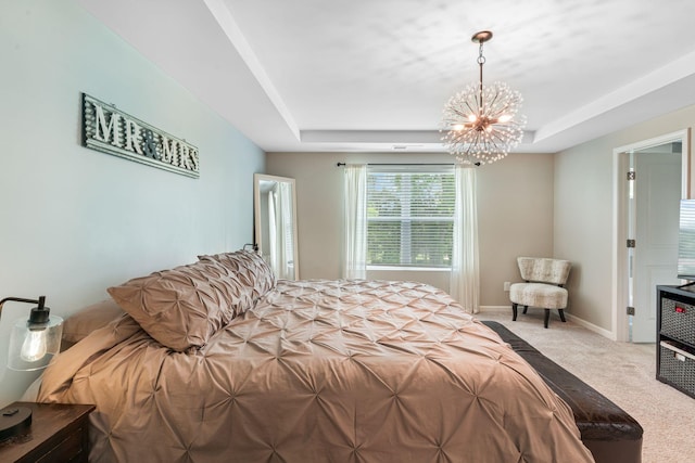 bedroom featuring carpet, baseboards, a raised ceiling, and a notable chandelier
