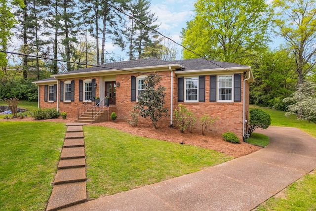 ranch-style home featuring brick siding and a front lawn