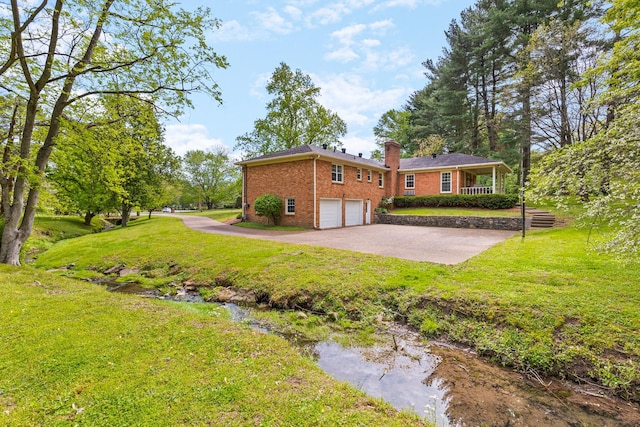 view of property exterior with a garage, a chimney, a yard, and brick siding