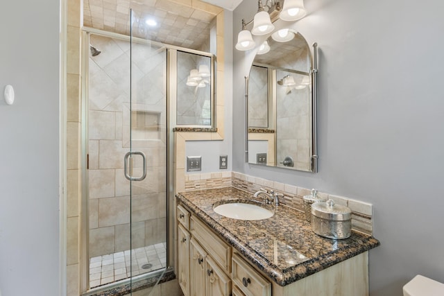 bathroom with a shower stall and vanity
