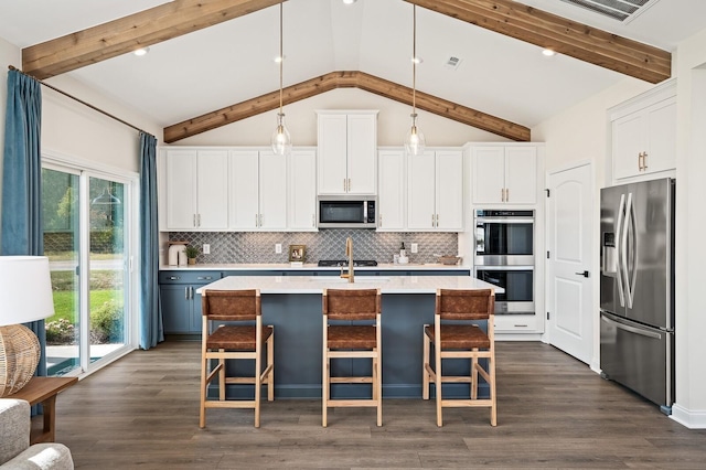 kitchen with light countertops, stainless steel appliances, decorative backsplash, and white cabinetry