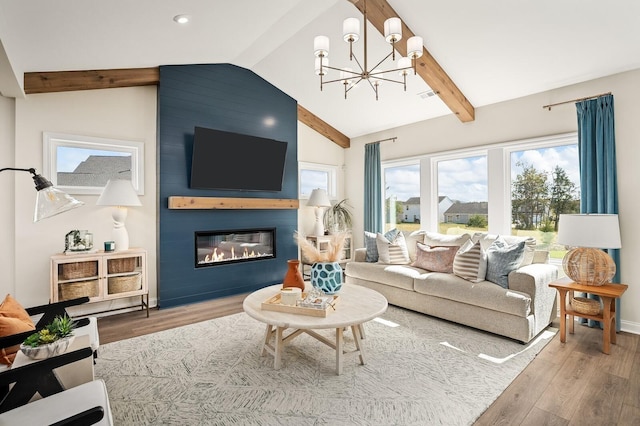 living area with visible vents, an inviting chandelier, wood finished floors, vaulted ceiling with beams, and a large fireplace
