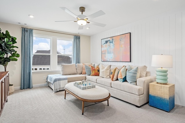 living room with baseboards, light carpet, a ceiling fan, and recessed lighting