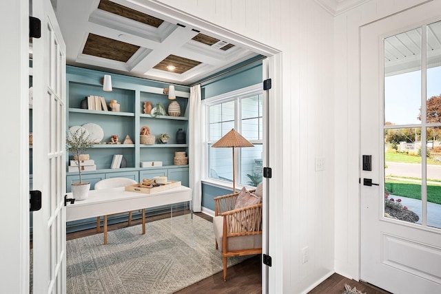 entryway with dark wood-type flooring, ornamental molding, and beamed ceiling