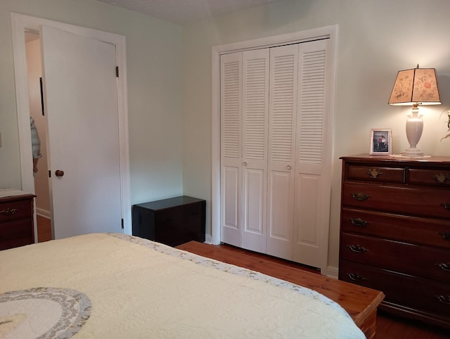 bedroom featuring wood finished floors and a closet