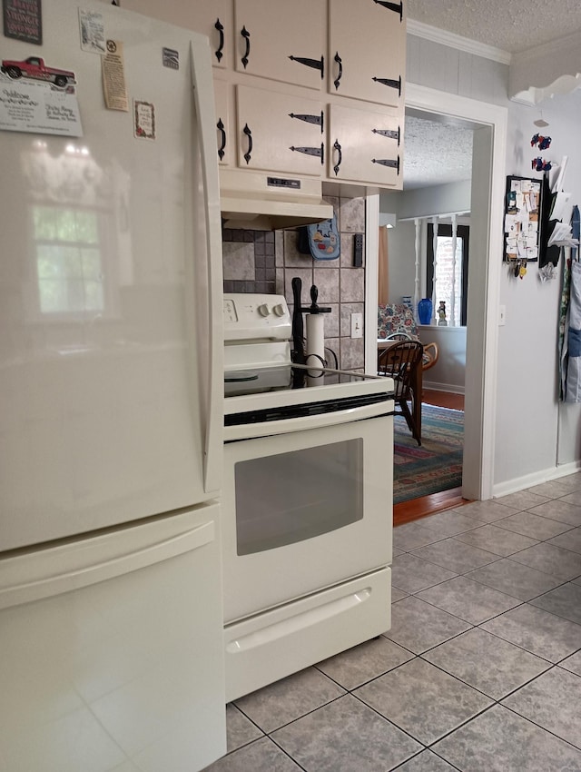 kitchen featuring white appliances, a textured ceiling, backsplash, under cabinet range hood, and ornamental molding