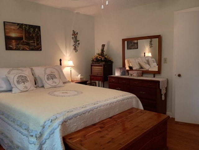 bedroom with wood finished floors