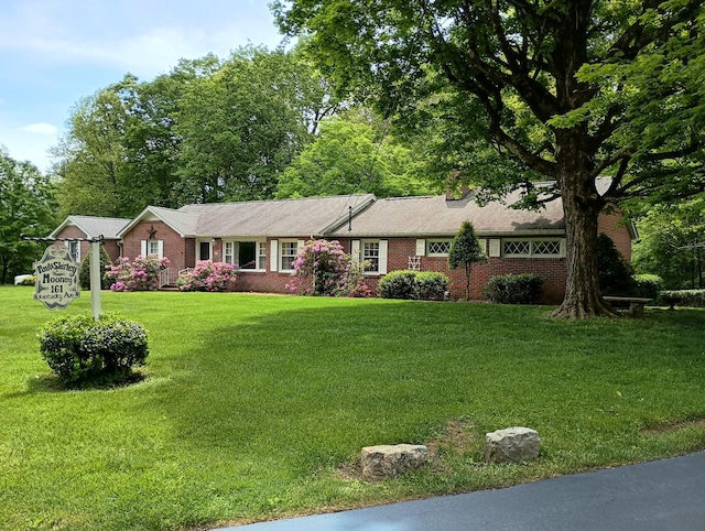 ranch-style house with brick siding and a front lawn
