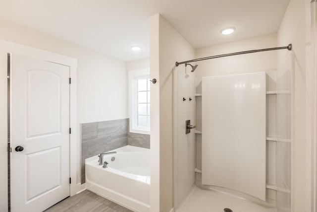 full bath with a shower stall and a bath
