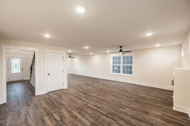 below grade area with baseboards, ceiling fan, recessed lighting, and dark wood-type flooring