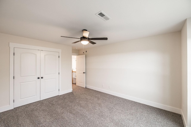 unfurnished bedroom with visible vents, baseboards, carpet floors, and a closet