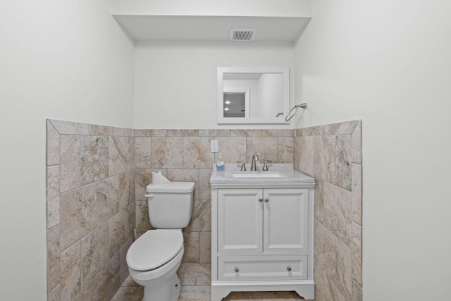8224 Victory Trl, Brentwood, TN 37027 - bathroom with tile walls, toilet, vanity, and a wainscoted wall