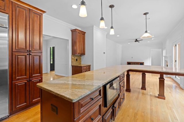 8224 Victory Trl, Brentwood, TN 37027 - kitchen with built in appliances, light wood-type flooring, crown molding, decorative light fixtures, and light stone countertops