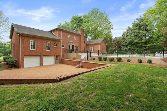 8224 Victory Trl, Brentwood, TN 37027 - back of property with brick siding, a garage, a chimney, and driveway