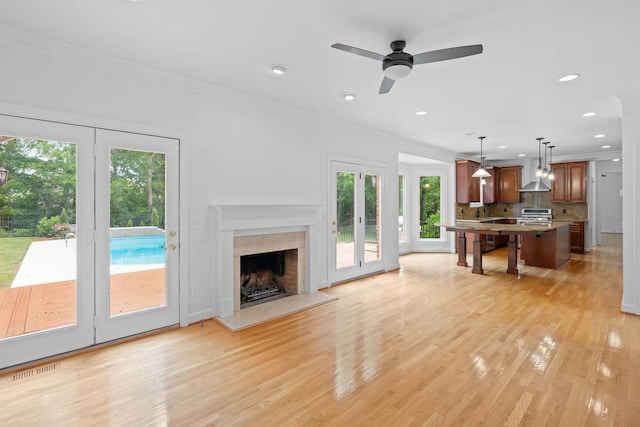 8224 Victory Trl, Brentwood, TN 37027 - living room with healthy amount of natural light, ornamental molding, light wood-style floors, a fireplace, and recessed lighting
