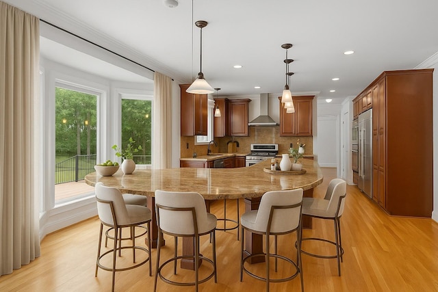 8224 Victory Trl, Brentwood, TN 37027 - kitchen featuring wall chimney exhaust hood, appliances with stainless steel finishes, light wood finished floors, a sink, and backsplash
