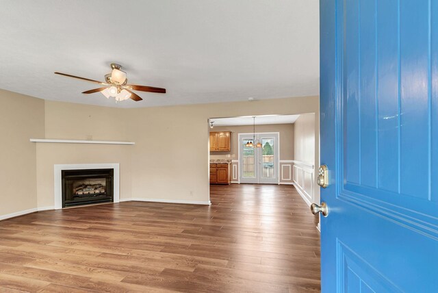 210 Edgewood Dr, Hohenwald, TN 38462 - unfurnished living room featuring a ceiling fan, wood finished floors, and a fireplace