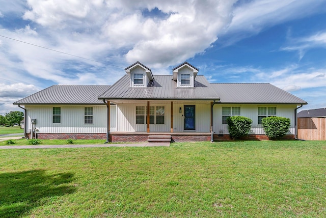 210 Edgewood Dr, Hohenwald, TN 38462 - view of front of property featuring covered porch, board and batten siding, a front lawn, and metal roof