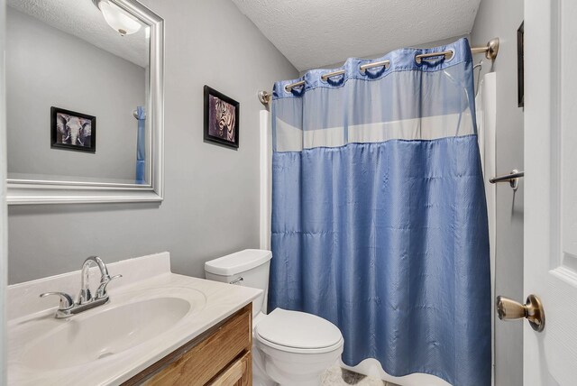 210 Edgewood Dr, Hohenwald, TN 38462 - bathroom featuring vanity, curtained shower, toilet, and a textured ceiling