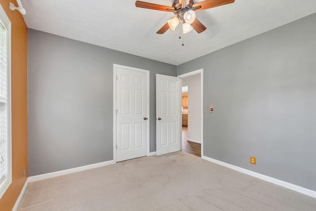 210 Edgewood Dr, Hohenwald, TN 38462 - unfurnished bedroom featuring carpet flooring, baseboards, ceiling fan, and a closet