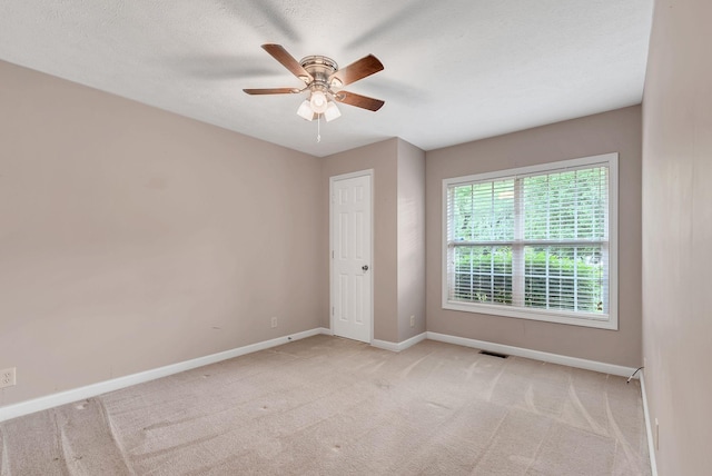210 Edgewood Dr, Hohenwald, TN 38462 - unfurnished room featuring baseboards, light carpet, a ceiling fan, and visible vents