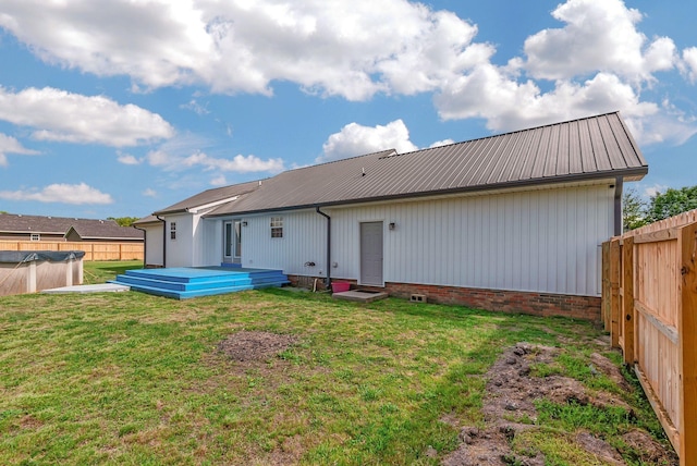 210 Edgewood Dr, Hohenwald, TN 38462 - back of property with a fenced backyard, a wooden deck, a yard, and metal roof