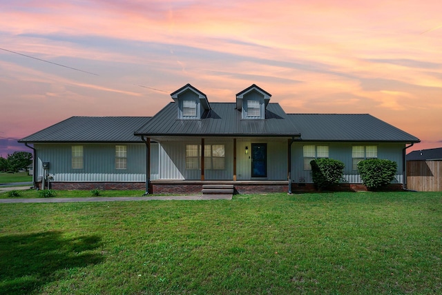 210 Edgewood Dr, Hohenwald, TN 38462 - view of front of home with a lawn, board and batten siding, a porch, and metal roof