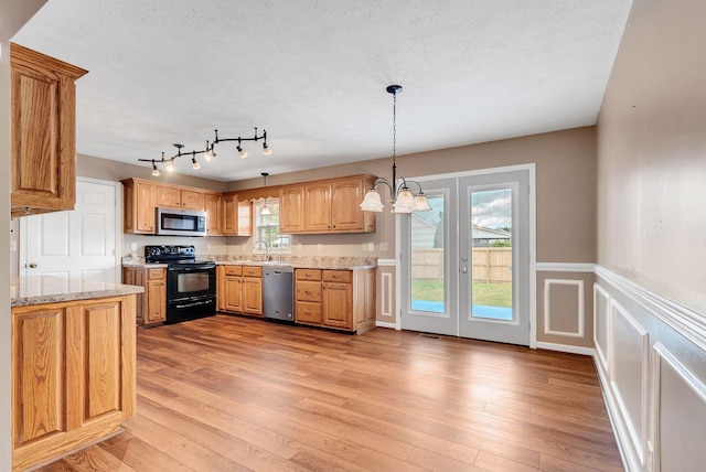 210 Edgewood Dr, Hohenwald, TN 38462 - kitchen featuring light wood-style floors, pendant lighting, stainless steel appliances, and a sink