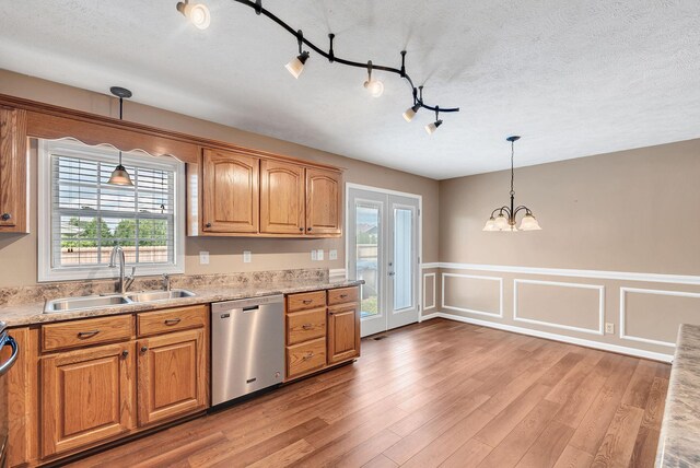 210 Edgewood Dr, Hohenwald, TN 38462 - kitchen with light wood-type flooring, a sink, dishwasher, a notable chandelier, and hanging light fixtures