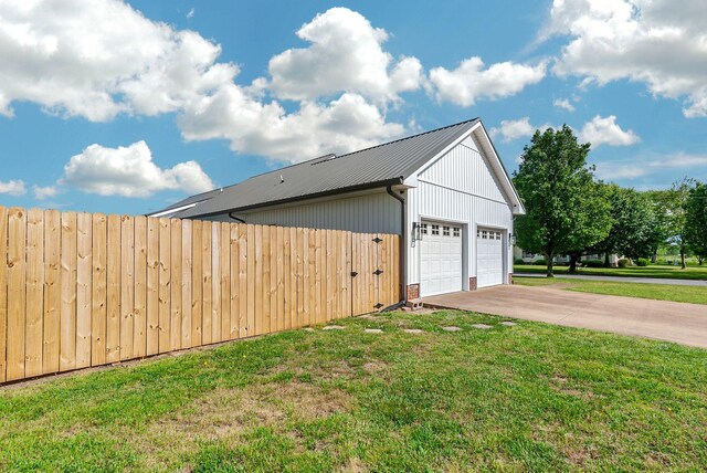 210 Edgewood Dr, Hohenwald, TN 38462 - view of home's exterior featuring fence, a yard, metal roof, and a garage