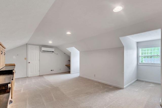 210 Edgewood Dr, Hohenwald, TN 38462 - additional living space featuring a wall mounted AC, vaulted ceiling, recessed lighting, and light colored carpet