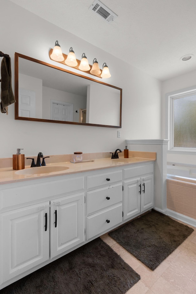 2011 Spring Meadow Cir, Spring Hill, TN 37174 - bathroom featuring double vanity, tiled tub, and tile patterned floors