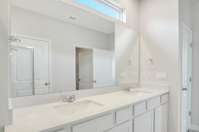 full bath featuring visible vents, a sink, and double vanity