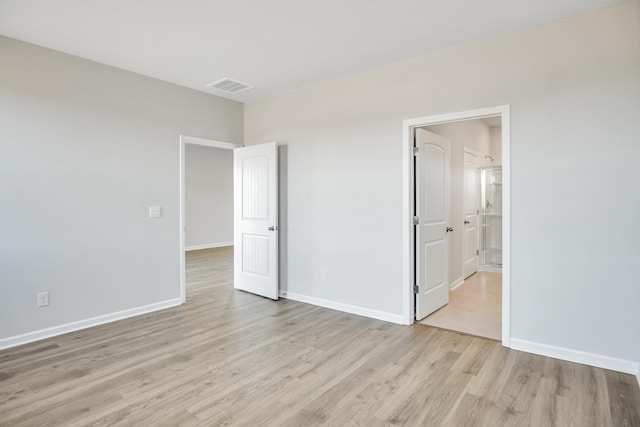 unfurnished bedroom with baseboards, visible vents, and light wood-style flooring
