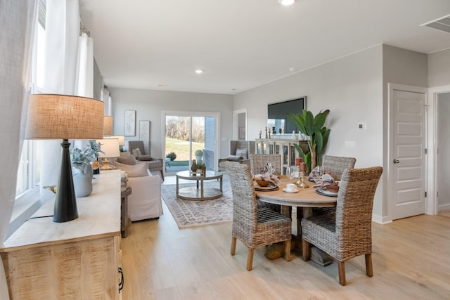 dining area with light wood-style floors and recessed lighting