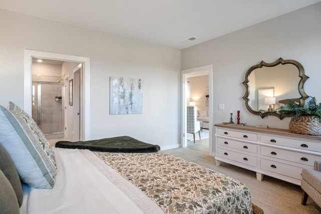 bedroom featuring light colored carpet, ensuite bath, and visible vents