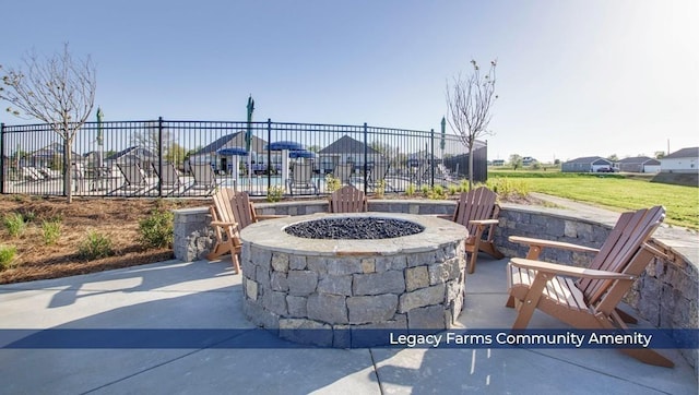 view of patio featuring fence and a fire pit