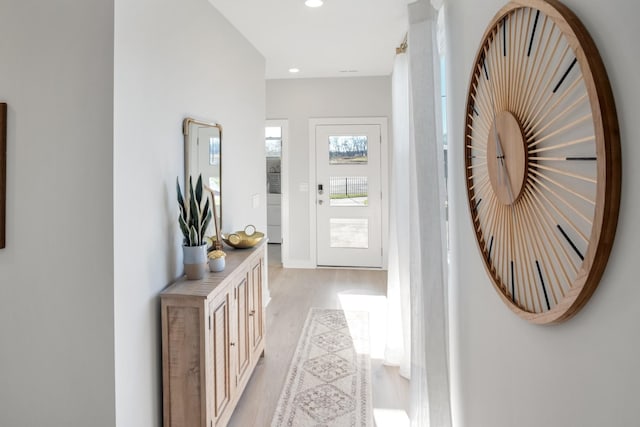 interior space with light wood-type flooring, recessed lighting, and baseboards