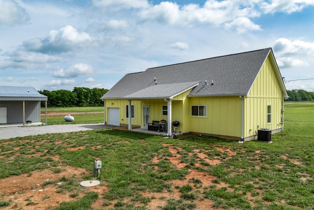 1317 Halls Mill Rd, Unionville, TN 37180 - rear view of property with a garage, board and batten siding, a yard, and gravel driveway