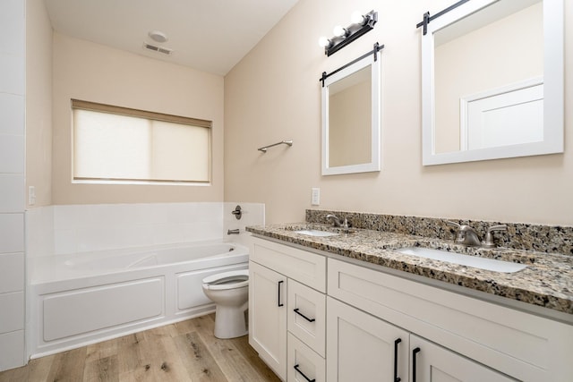 1317 Halls Mill Rd, Unionville, TN 37180 - bathroom with a sink, a garden tub, wood finished floors, and visible vents