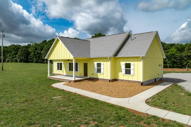 1317 Halls Mill Rd, Unionville, TN 37180 - back of house featuring ceiling fan, a patio, a shingled roof, board and batten siding, and a yard