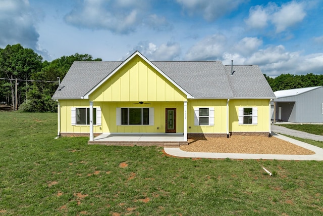 1317 Halls Mill Rd, Unionville, TN 37180 - view of front of property featuring board and batten siding, a ceiling fan, a patio area, a front lawn, and a shingled roof