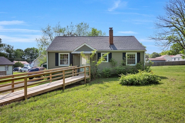 single story home featuring a wooden deck, fence, a front yard, roof with shingles, and a chimney