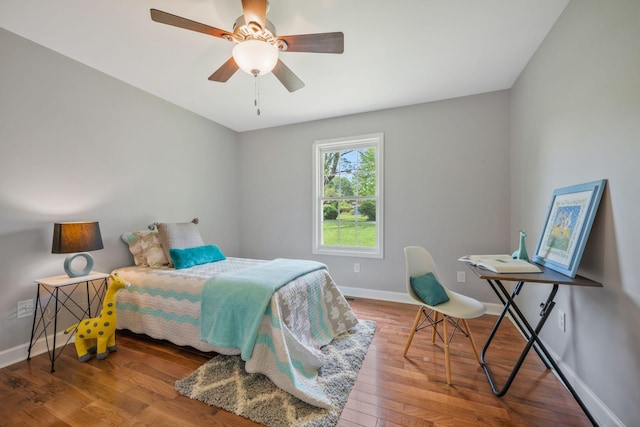 bedroom featuring baseboards, a ceiling fan, and wood finished floors
