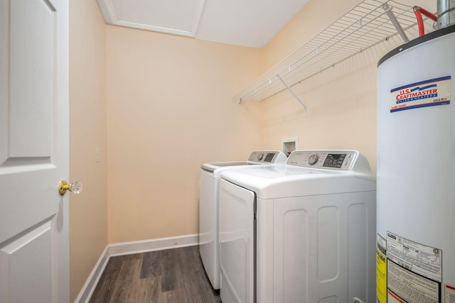 laundry room featuring laundry area, dark wood finished floors, baseboards, water heater, and separate washer and dryer