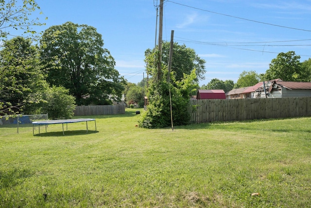 view of yard featuring a fenced backyard and a trampoline
