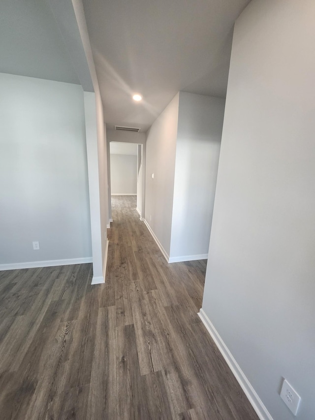 hall featuring baseboards, visible vents, recessed lighting, and dark wood-type flooring
